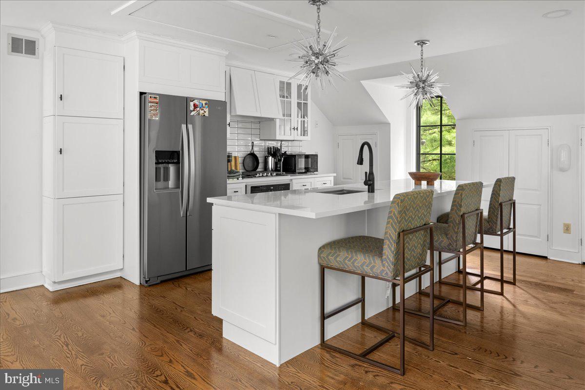 6450 Old Carversville Road New Hope, PA 18938 - Photo 78 of 89 a kitchen with stainless steel appliances granite countertop a dining table chairs a refrigerator and a window