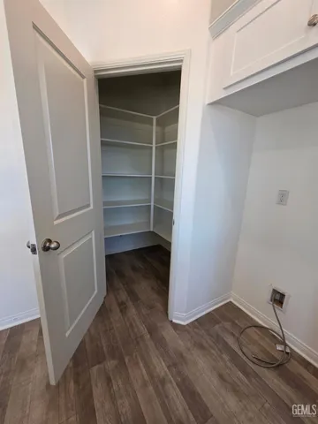 a view of a room with wooden floor