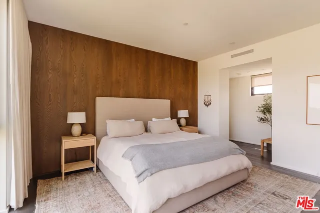 a bathroom with a double vanity sink a mirror and a bathtub