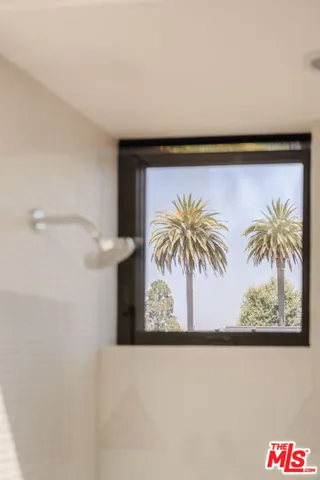 a bedroom with a bed and a night stand