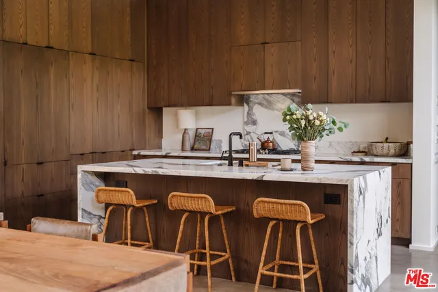 a kitchen with cabinets a sink and white appliances