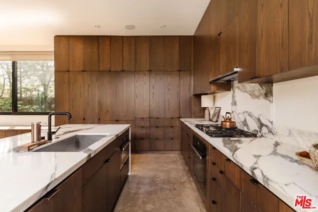 a kitchen with a sink stove and cabinets