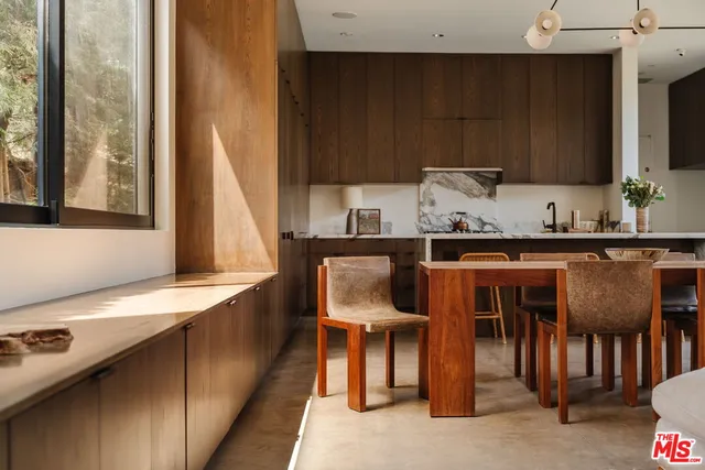 a dining room with furniture and a window