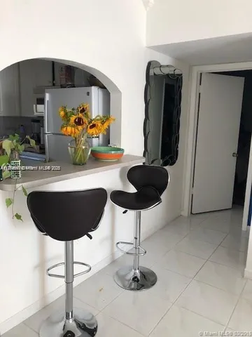 a table with chairs and a potted plant in it