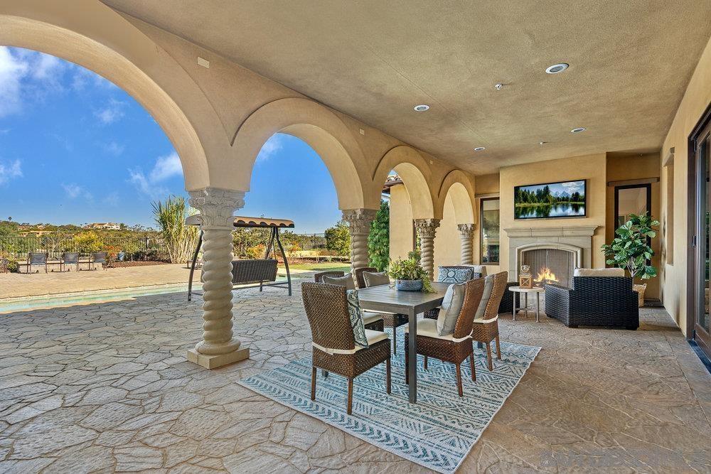 6702 St Andrews Road Rancho Santa Fe, CA 92067 - Photo 17 of 17 a living room with fireplace furniture and a floor to ceiling window