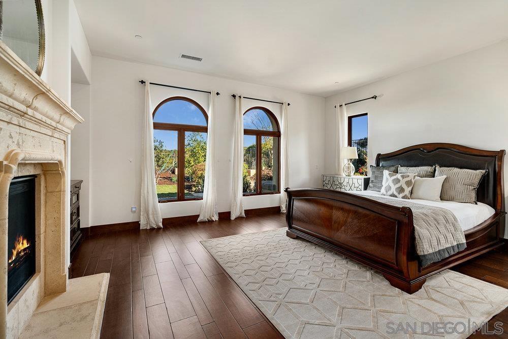 6702 St Andrews Road Rancho Santa Fe, CA 92067 - Photo 9 of 17 a spacious bedroom with a bed and a large window