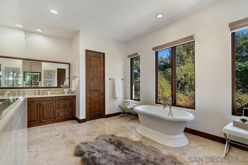 6702 St Andrews Road Rancho Santa Fe, CA 92067 - Photo 10 of 17 a bathroom with a tub sink and mirror