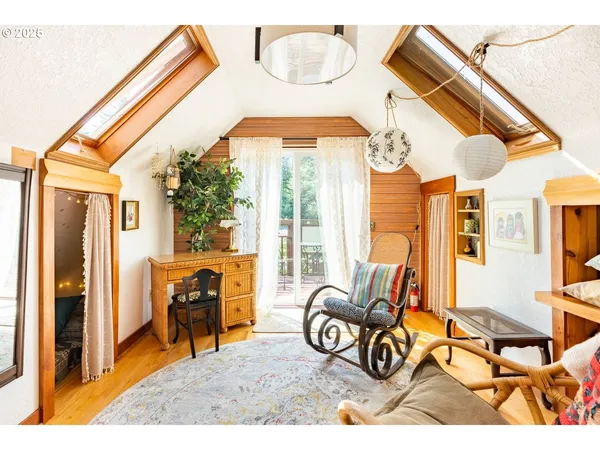 a view of living room filled with furniture and floor to ceiling windows