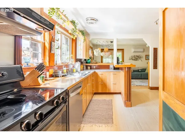 a open kitchen with stainless steel appliances granite countertop a sink and counter space
