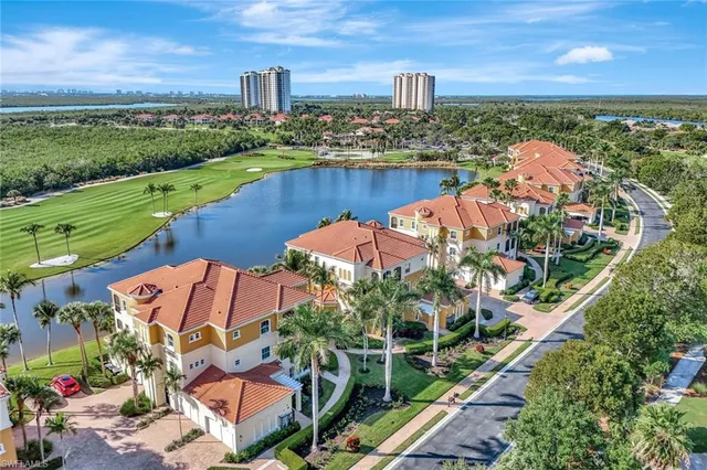 an aerial view of a house with a garden and lake view