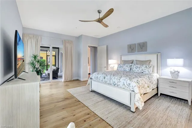 a view of a dining room with furniture a chandelier and wooden floor