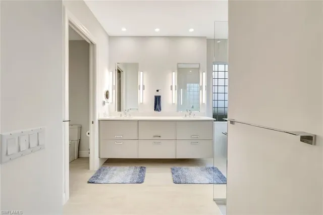 a spacious bathroom with a double vanity sink mirror and double