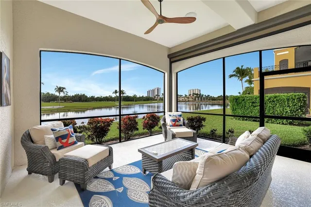 a living room with furniture and a floor to ceiling window