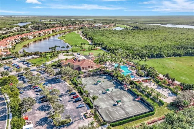 an aerial view of residential houses with outdoor space and trees