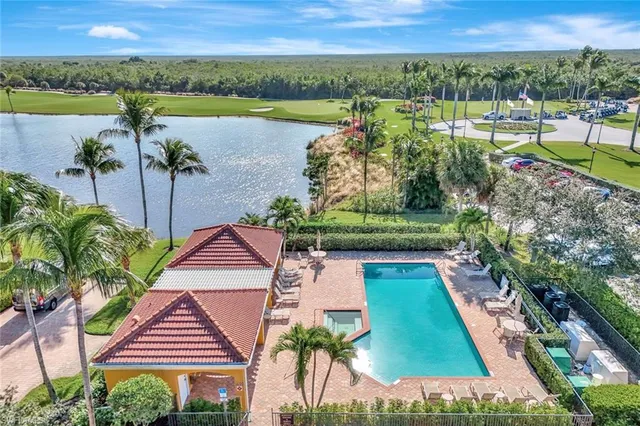 an aerial view of a house with a garden and lake view
