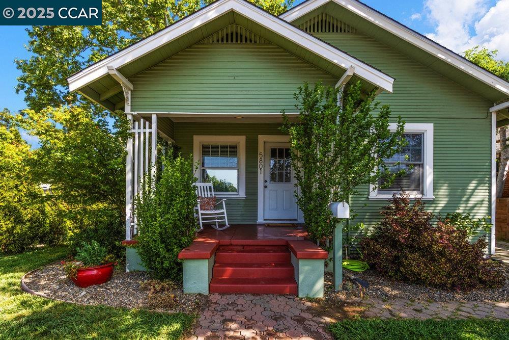 a front view of a house with plants