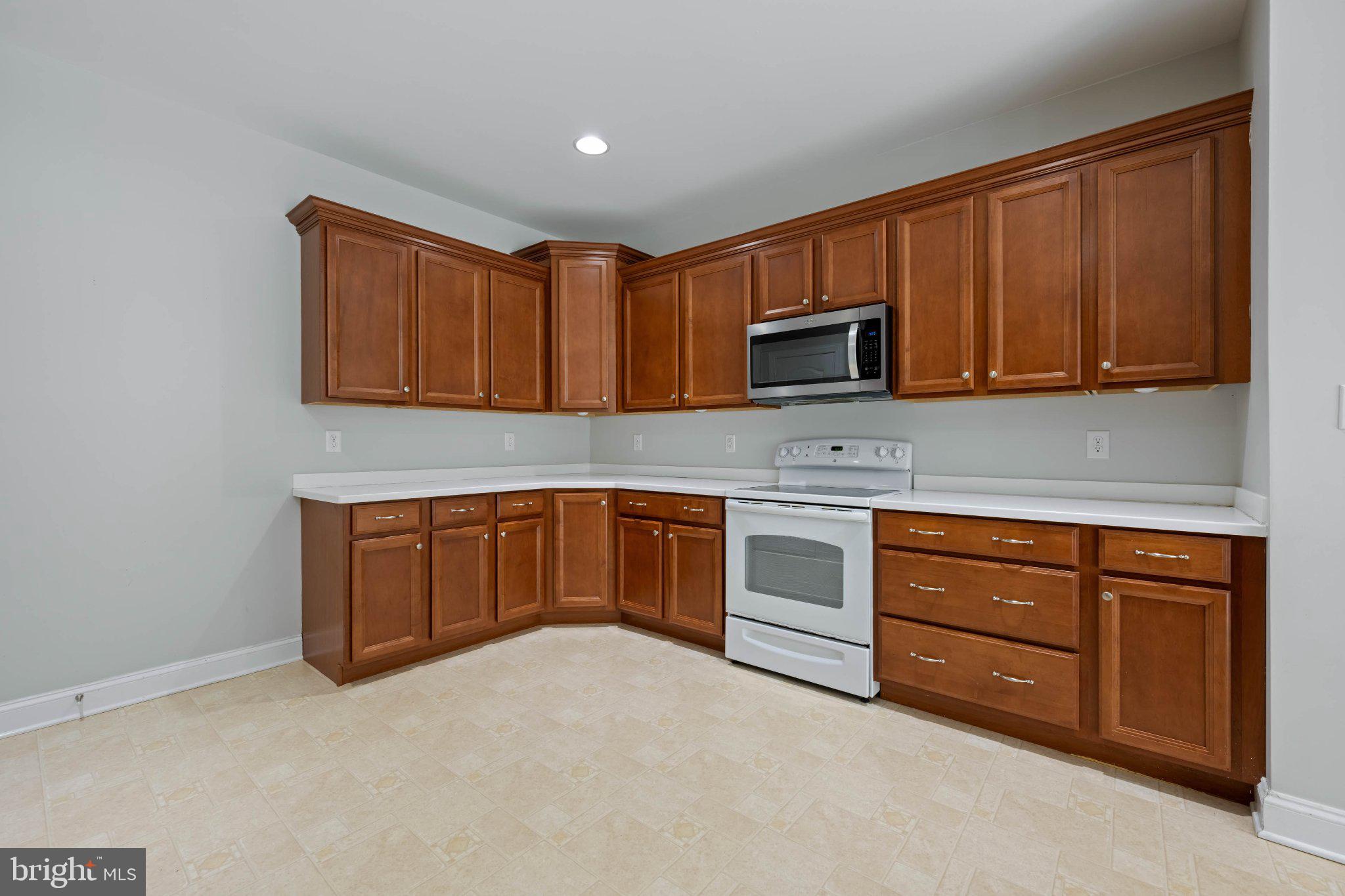 28751 Valley View Lane Lewes, DE 19958 - Photo 19 of 38 Modern kitchen with rich wood cabinetry.