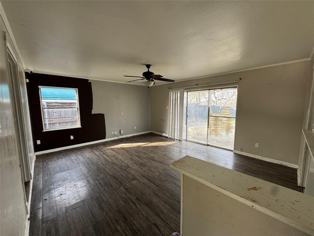 625 Midvale Drive Dallas, TX 75232 - Photo 4 of 11 an empty room with wooden floor and windows