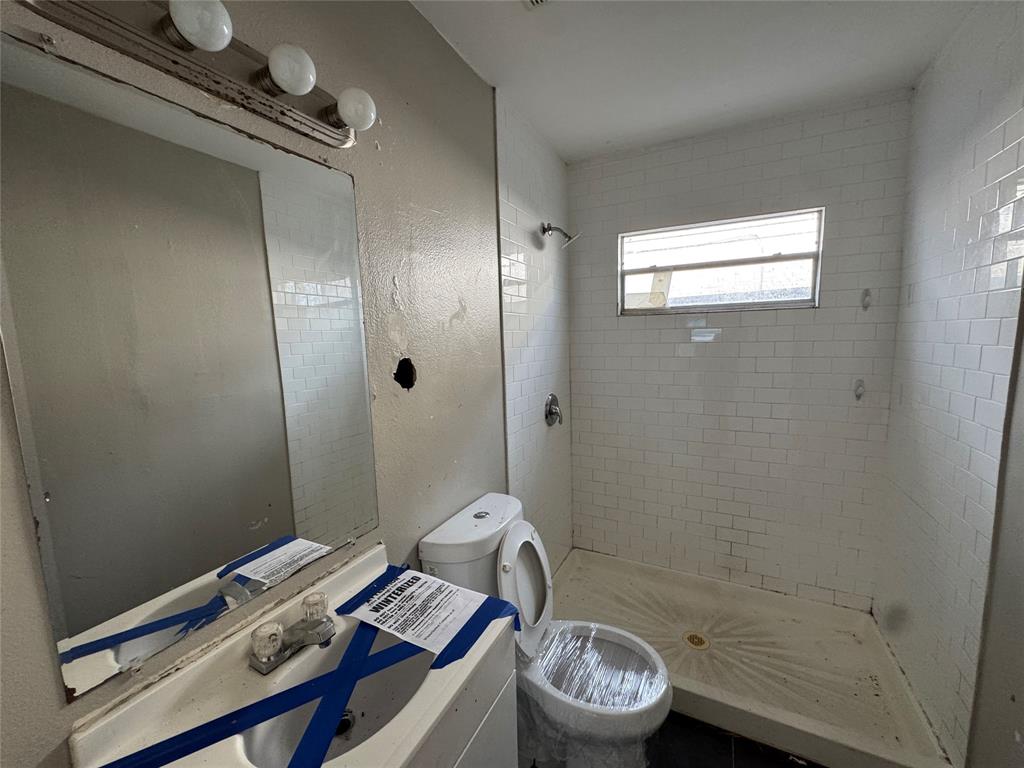 625 Midvale Drive Dallas, TX 75232 - Photo 9 of 11 a bathroom with a sink a toilet and shower