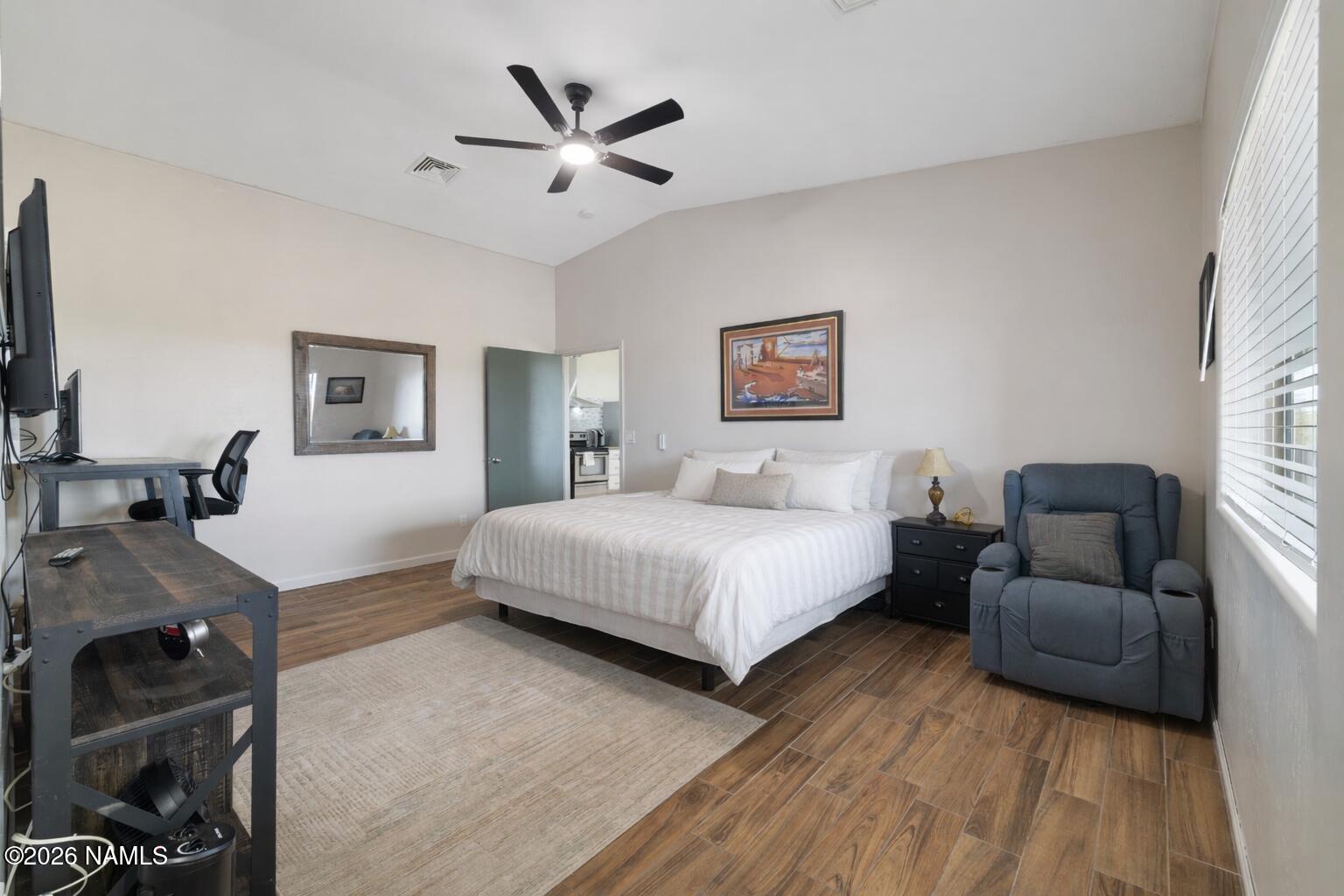 3097 Whitetail Loop Williams, AZ 86046 - Photo 13 of 46 a spacious bedroom with a bed couch and a window