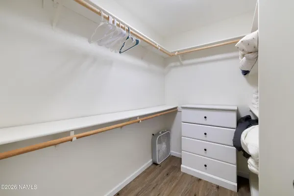 a bedroom with a bed chandelier and a window