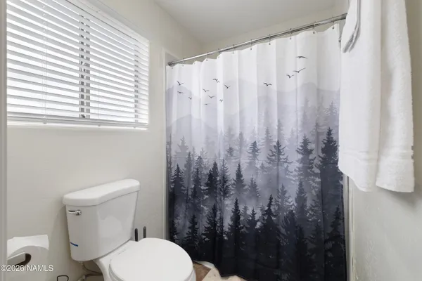 a bedroom with a bed dresser and a window