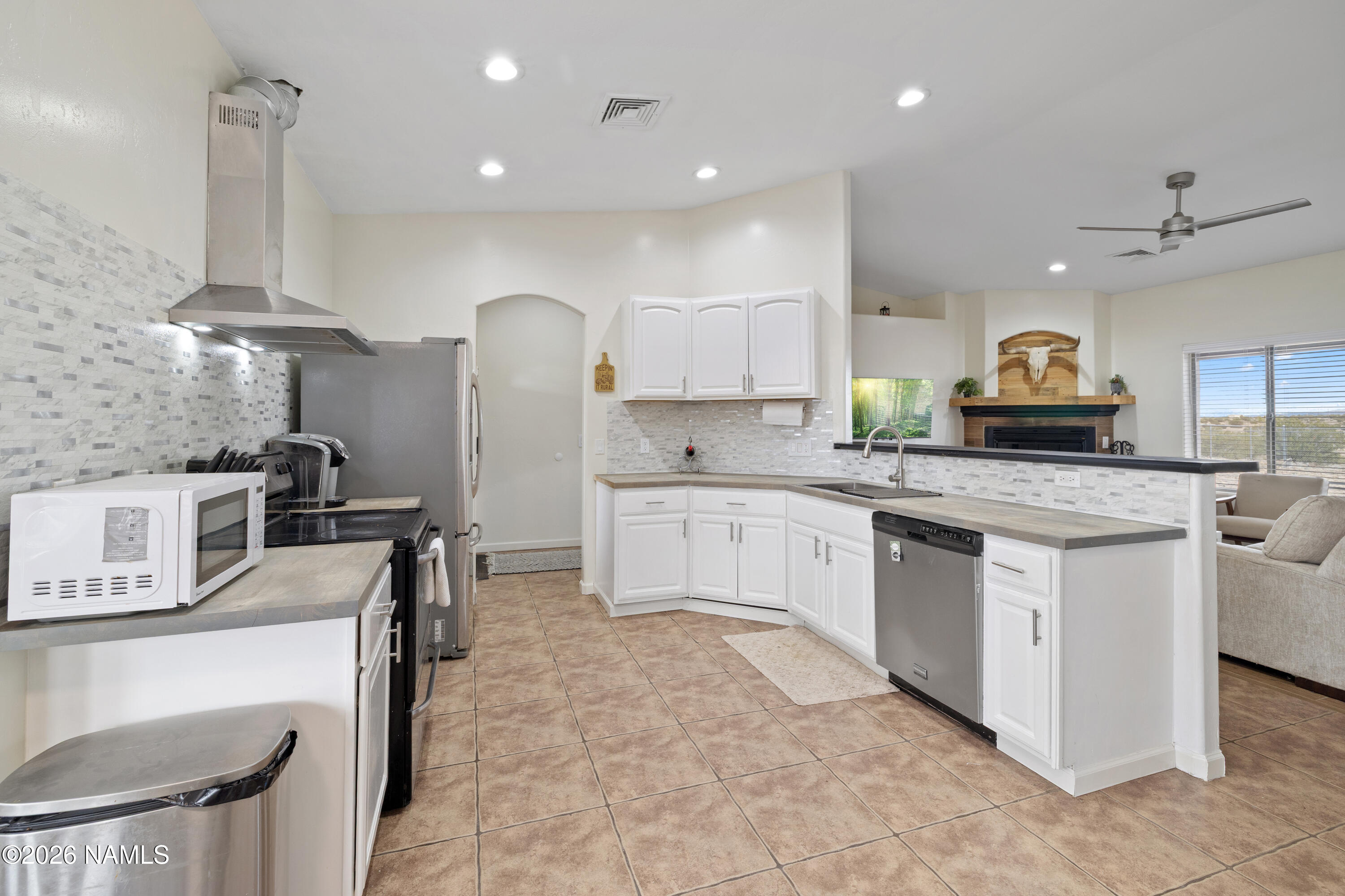 3097 Whitetail Loop Williams, AZ 86046 - Photo 10 of 46 a kitchen with stainless steel appliances granite countertop a stove top oven a sink a counter space and cabinets