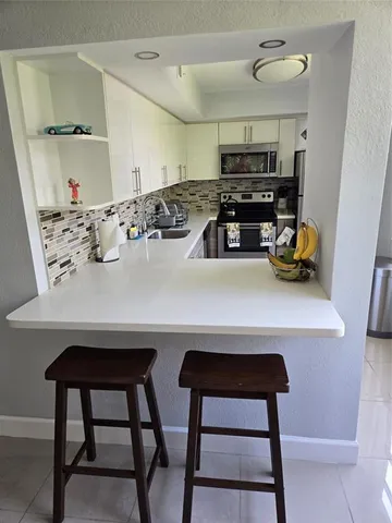 a view of a chairs and a table in a room