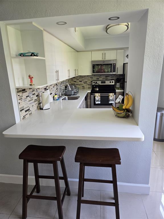 9400 Live Oak Place, Unit 305 Davie, FL 33324 - Photo 11 of 93 Pass Thru with Bar Seats.