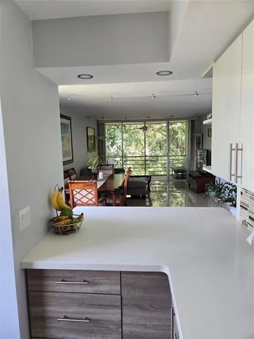 a dining room with furniture a large window and a rug