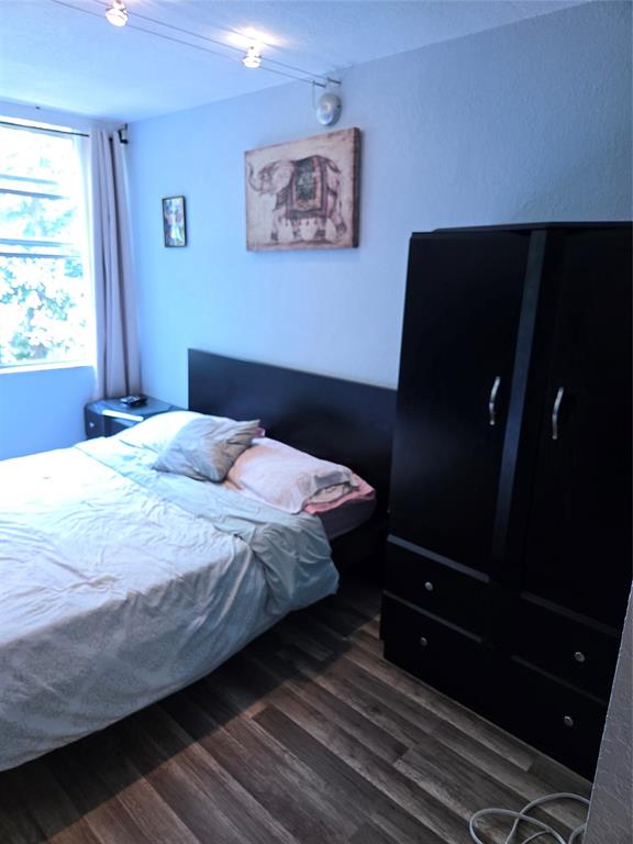 9400 Live Oak Place, Unit 305 Davie, FL 33324 - Photo 35 of 93 a bedroom with a bed and wooden floor