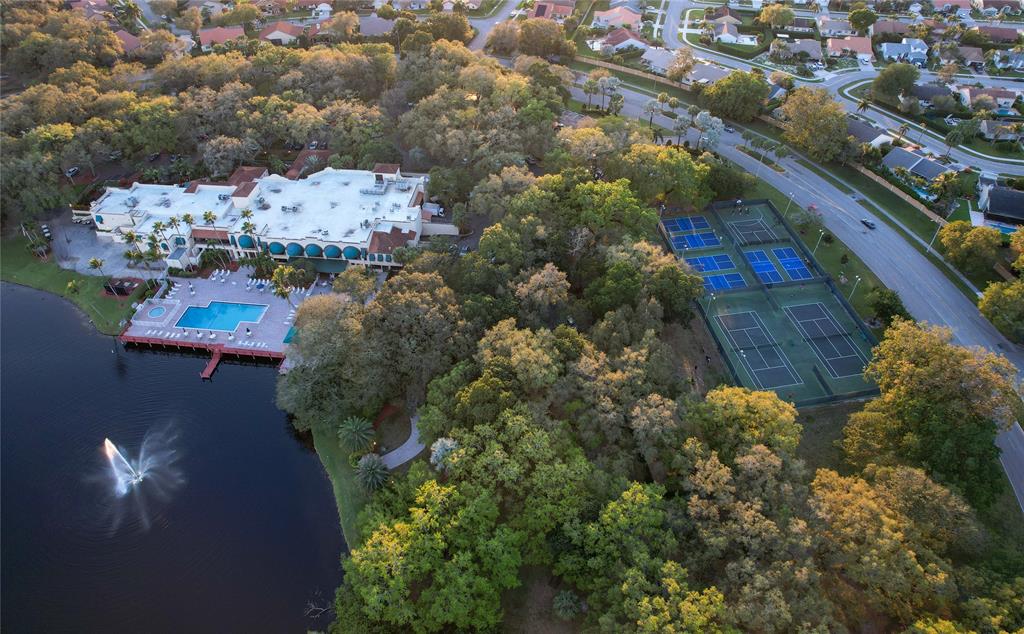 9400 Live Oak Place, Unit 305 Davie, FL 33324 - Photo 69 of 93 Drone Shot Overlooking Clubhouse Fountain and Tennis Courts.