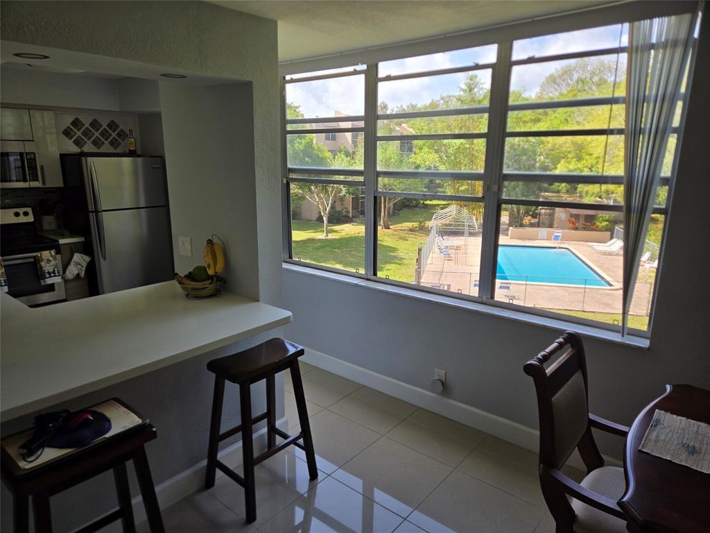 9400 Live Oak Place, Unit 305 Davie, FL 33324 - Photo 7 of 93 a view of a workspace with furniture and a window