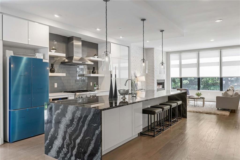 914 Lenox Boulevard Atlanta, GA 30324 - Photo 11 of 48 a kitchen with stainless steel appliances granite countertop a refrigerator a stove a sink and a dining table with wooden floor