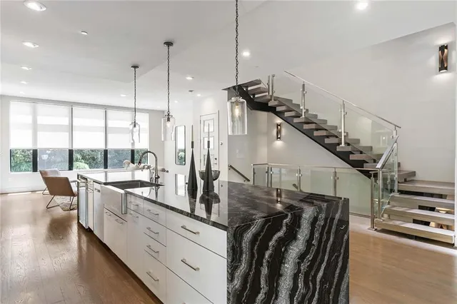 a kitchen with stainless steel appliances granite countertop a stove a sink and a refrigerator