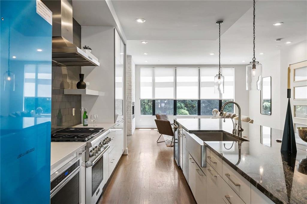 914 Lenox Boulevard Atlanta, GA 30324 - Photo 13 of 48 a kitchen with stainless steel appliances granite countertop a stove a sink and a refrigerator