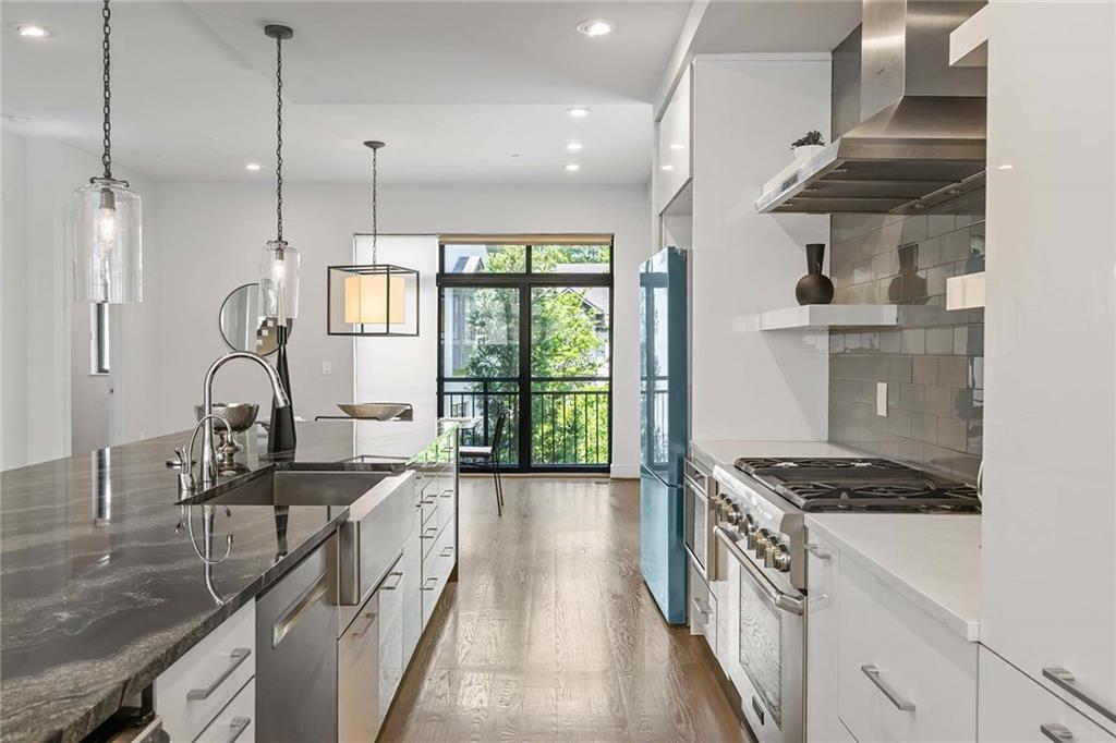 914 Lenox Boulevard Atlanta, GA 30324 - Photo 14 of 48 a kitchen with stainless steel appliances granite countertop a stove a sink and a refrigerator