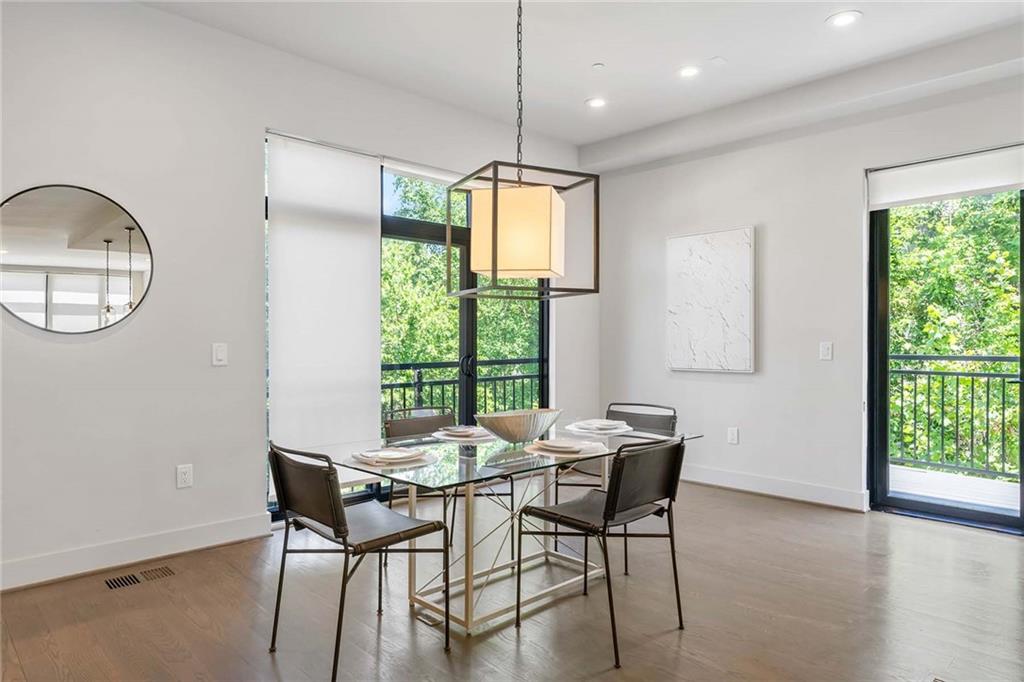 914 Lenox Boulevard Atlanta, GA 30324 - Photo 16 of 48 a dining room with furniture a chandelier and wooden floor