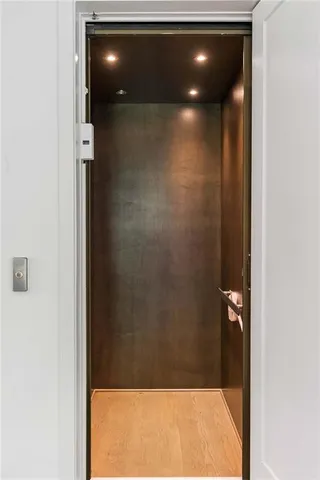 a large bed sitting in a bedroom next to a window