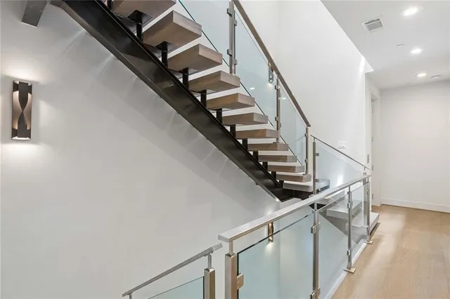 a bedroom with a bed a desk and chair with wooden floor