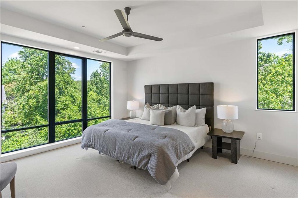 914 Lenox Boulevard Atlanta, GA 30324 - Photo 23 of 48 a large bed sitting in a bedroom next to a window