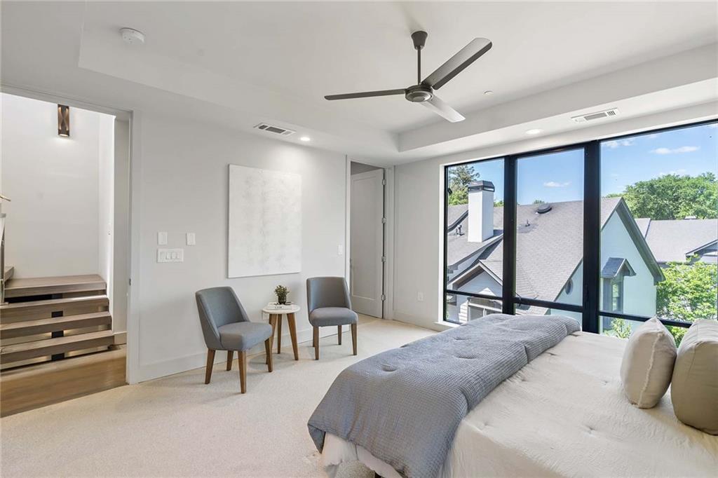 914 Lenox Boulevard Atlanta, GA 30324 - Photo 24 of 48 a bedroom with a bed a desk and chair with wooden floor