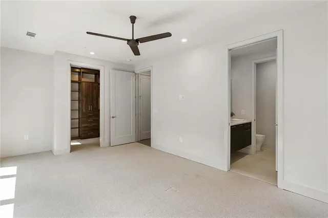 a bathroom with a granite countertop sink and a mirror with toilet