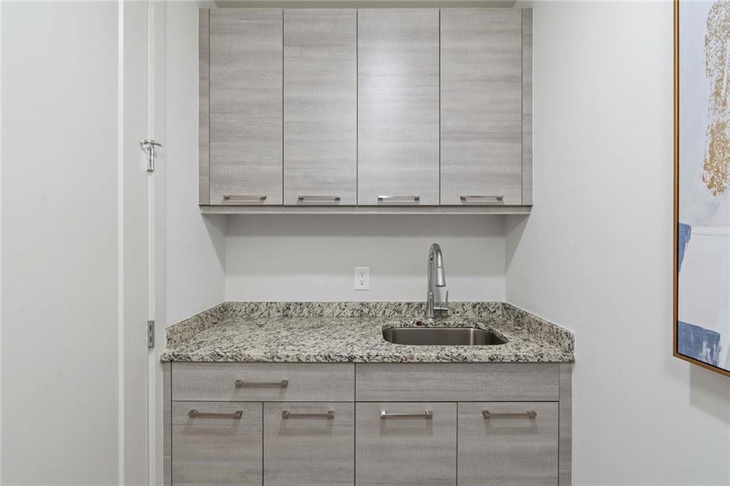 914 Lenox Boulevard Atlanta, GA 30324 - Photo 33 of 48 a bathroom with a granite countertop sink and cabinets