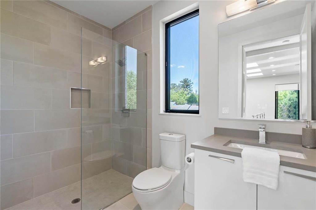 914 Lenox Boulevard Atlanta, GA 30324 - Photo 36 of 48 a bathroom with a sink toilet and shower