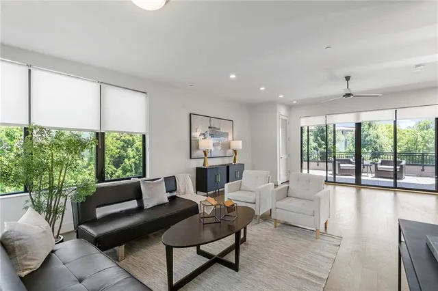a view of a roof deck with couches and potted plants