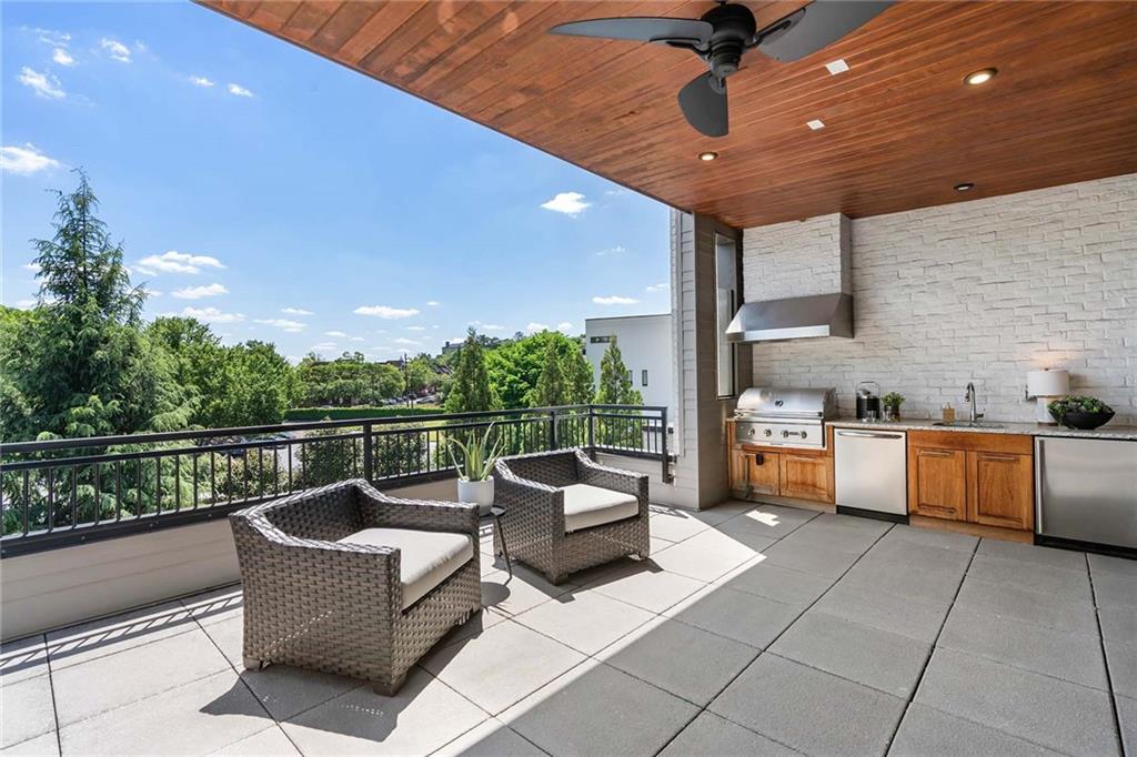 914 Lenox Boulevard Atlanta, GA 30324 - Photo 42 of 48 a view of a roof deck with couches and potted plants