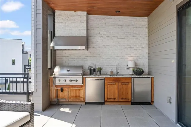 a view of backyard with large windows and wooden floor