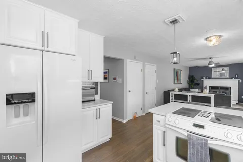 a kitchen with stainless steel appliances a stove a refrigerator and a refrigerator