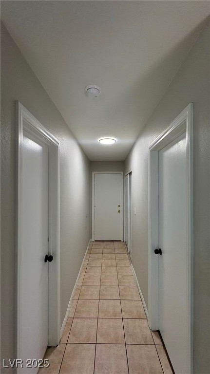 7113 Pinelake Road Las Vegas, NV 89145 - Photo 15 of 22 Hallway featuring light tile patterned floors and baseboards